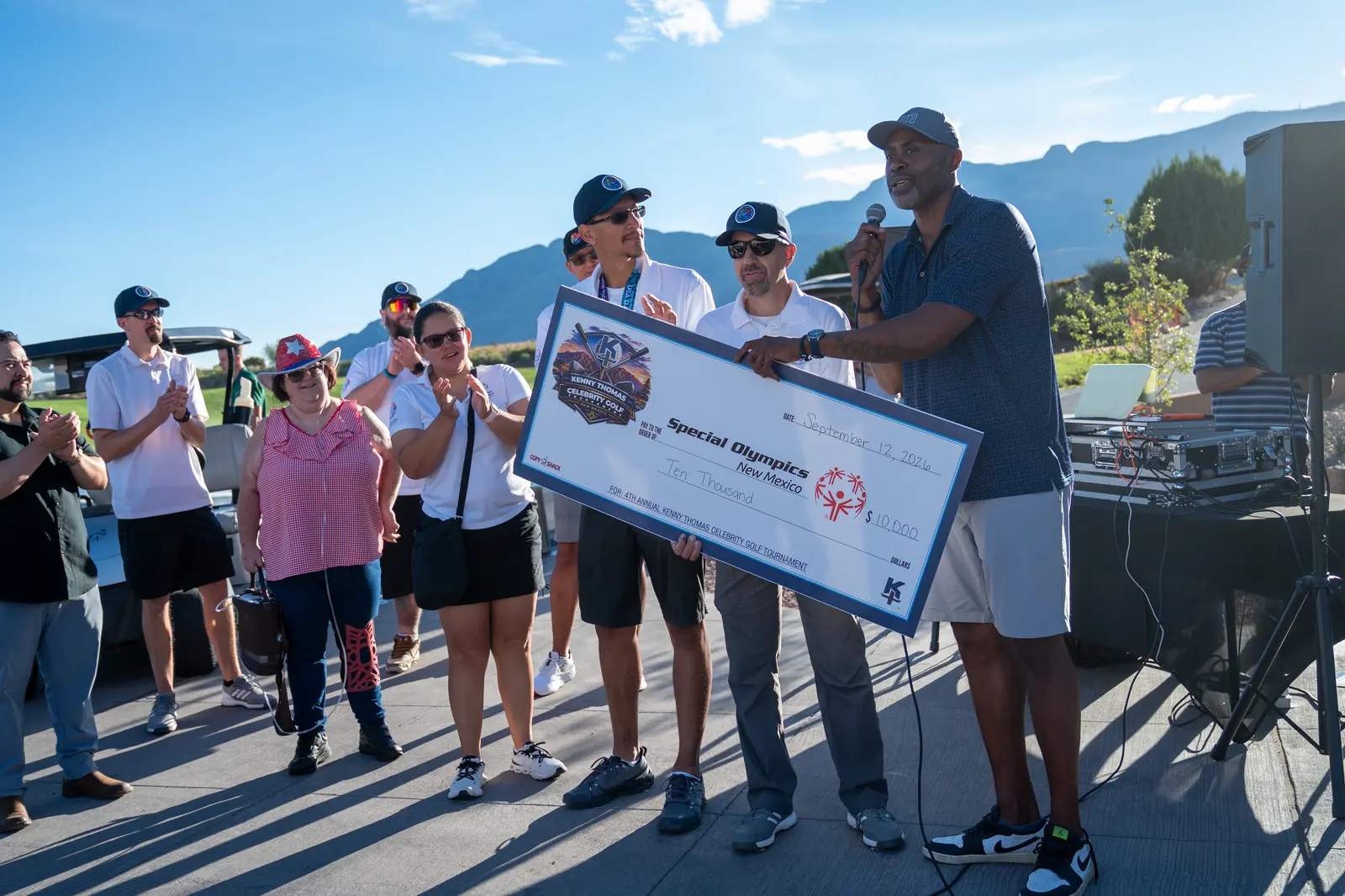 Kenny Thomas presenting a donation check to Special Olympics New Mexico