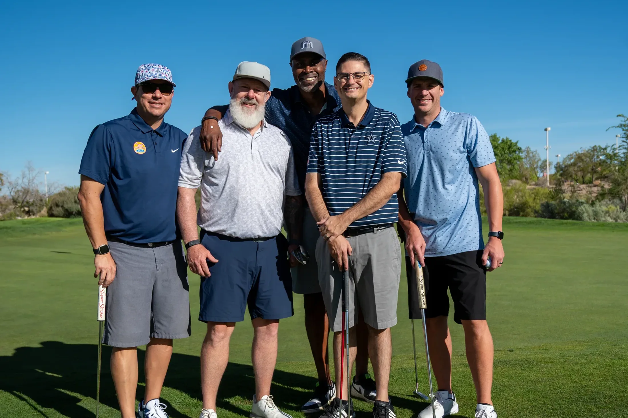 Kenny Thomas and players on the course at the Celebrity Golf Tournament